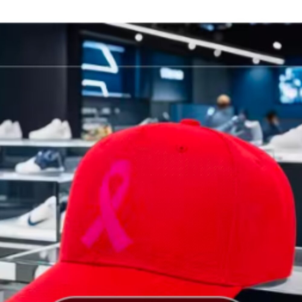 Red cap with breast cancer symbol ( ribbon) on the front.
